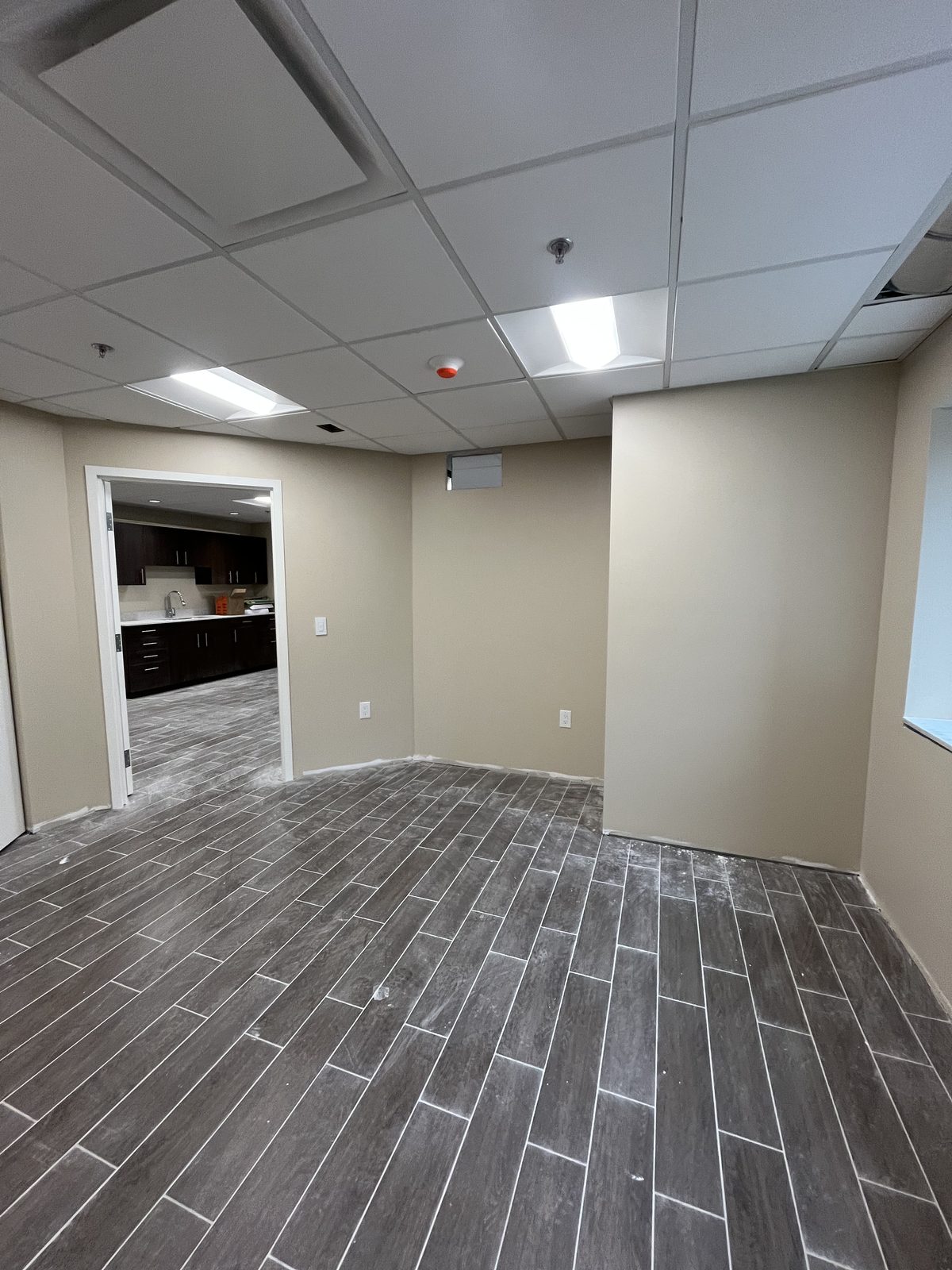 Room with beige painted walls and a white-trimmed doorway leading to a kitchenette at 40 Polonia in Brampton