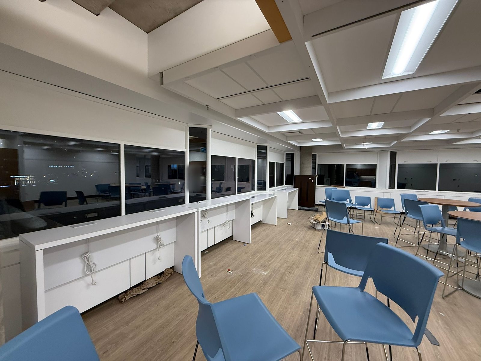 Open lounge and café area with white painted walls, white millwork counters and a white coffered ceiling on the 6th floor at 4900 Yonge Street, Toronto