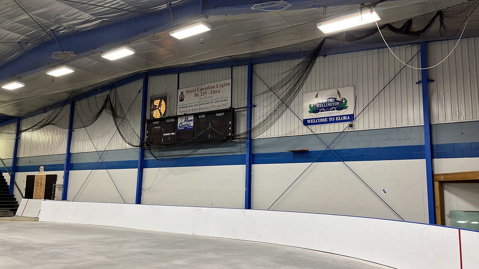 Elora Community Centre arena with painted blue steel columns, white walls and rink boards