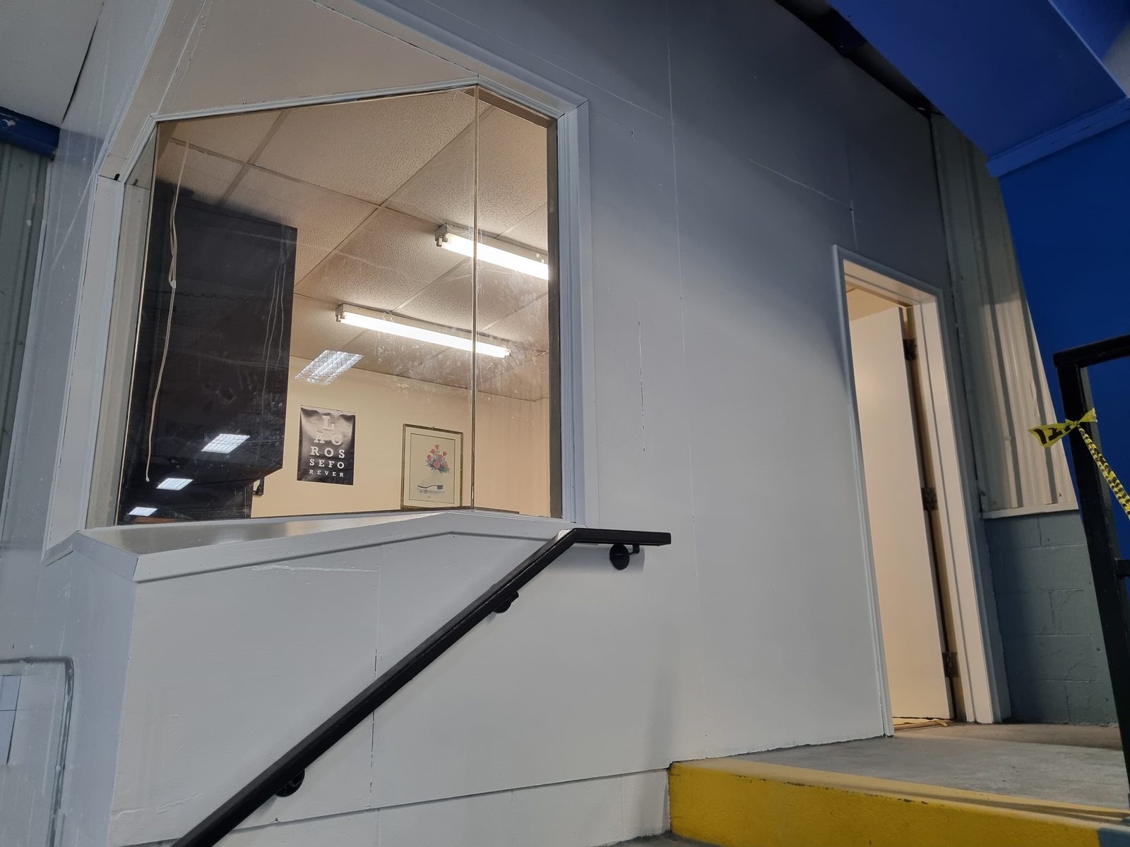 Office window and handrail on a painted grey wall, Elora Community Centre