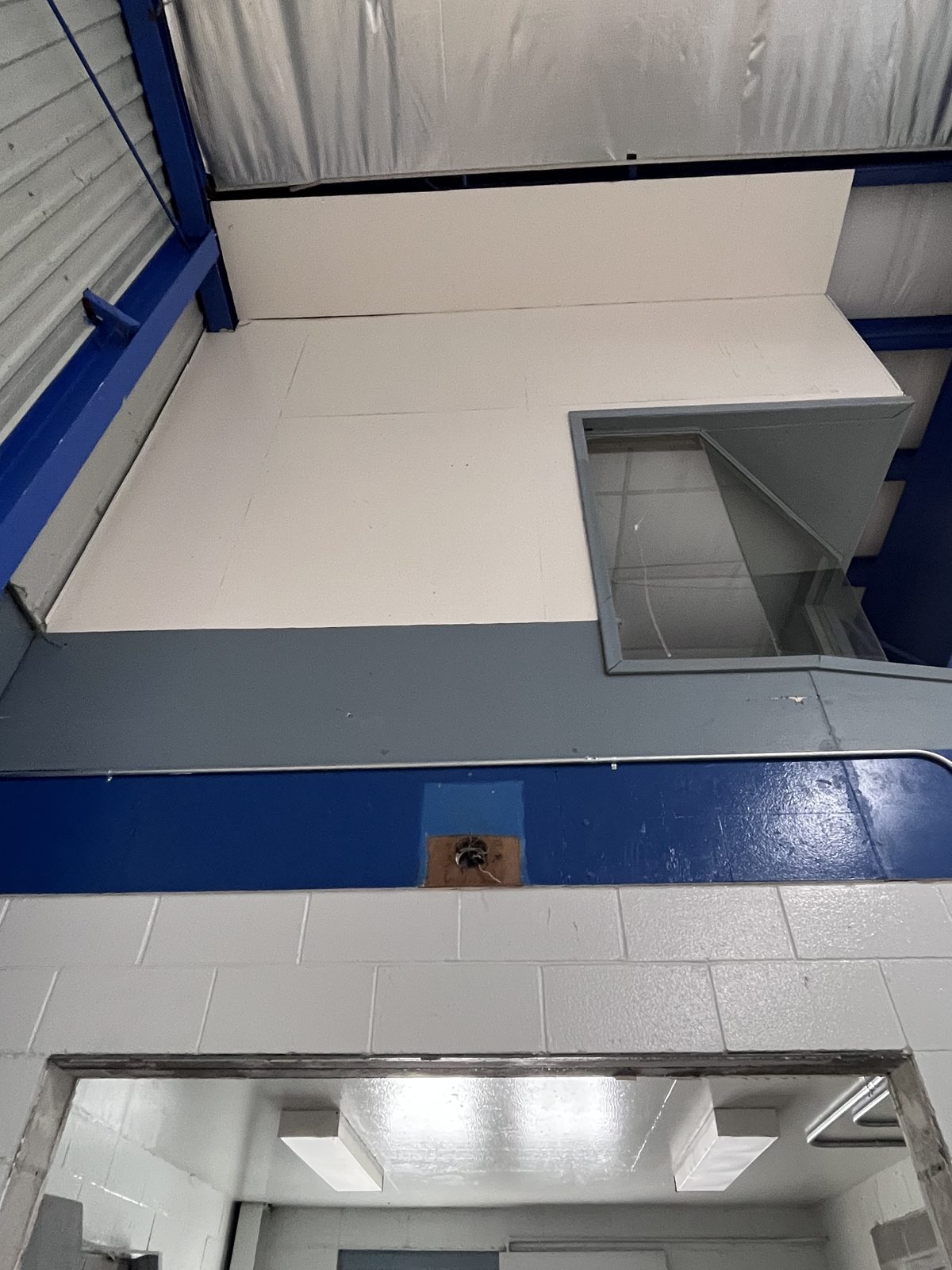 Painted upper booth and blue trim seen from below, Elora Community Centre