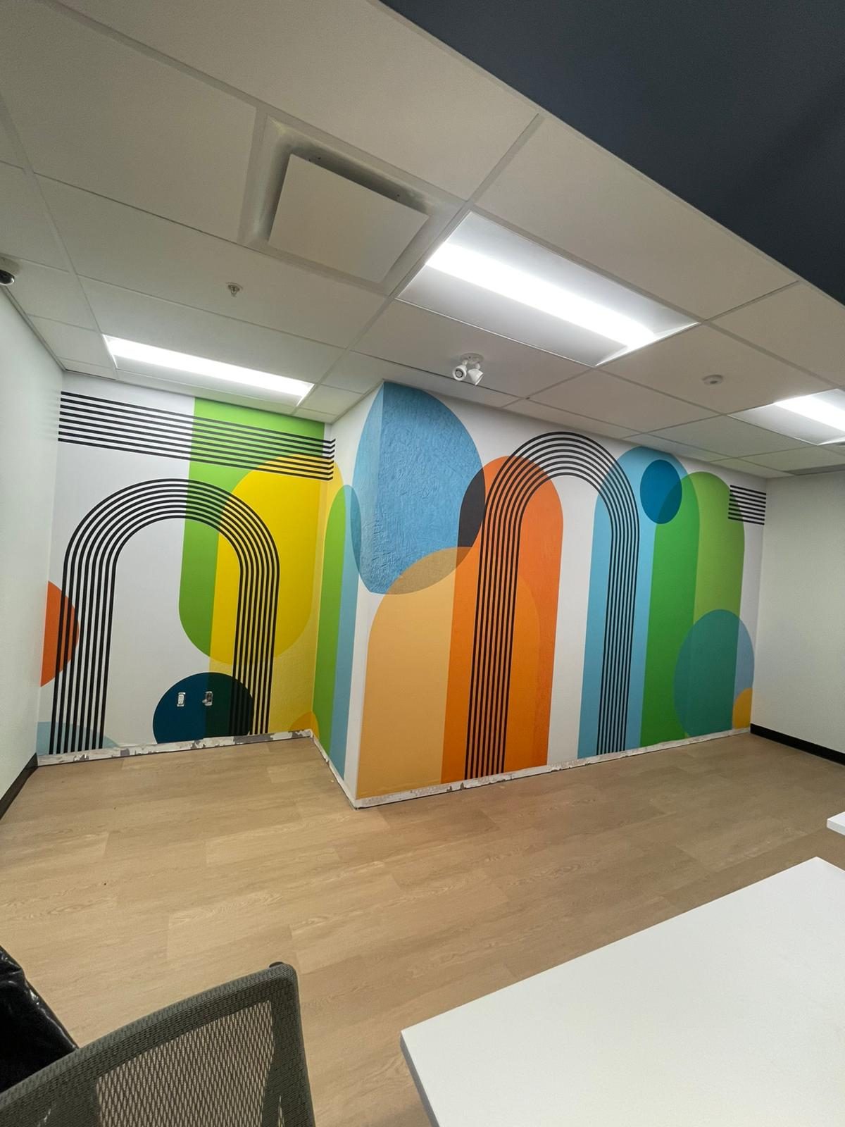Colourful geometric arches feature-wall mural in a renovated room in Building B at Georgian College in Barrie