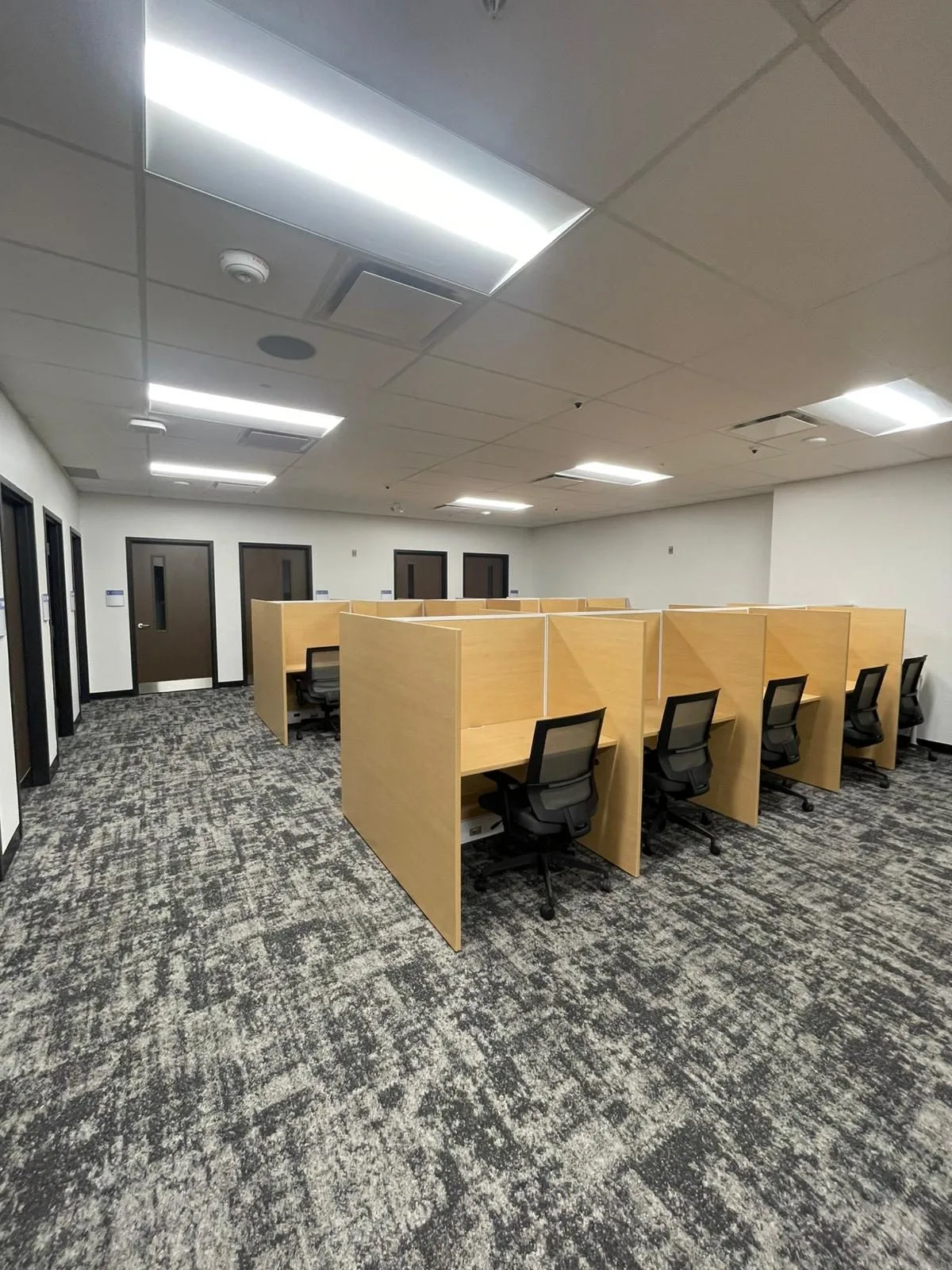 Study carrel area with freshly painted white walls and dark-trimmed doors in Building B at Georgian College in Barrie