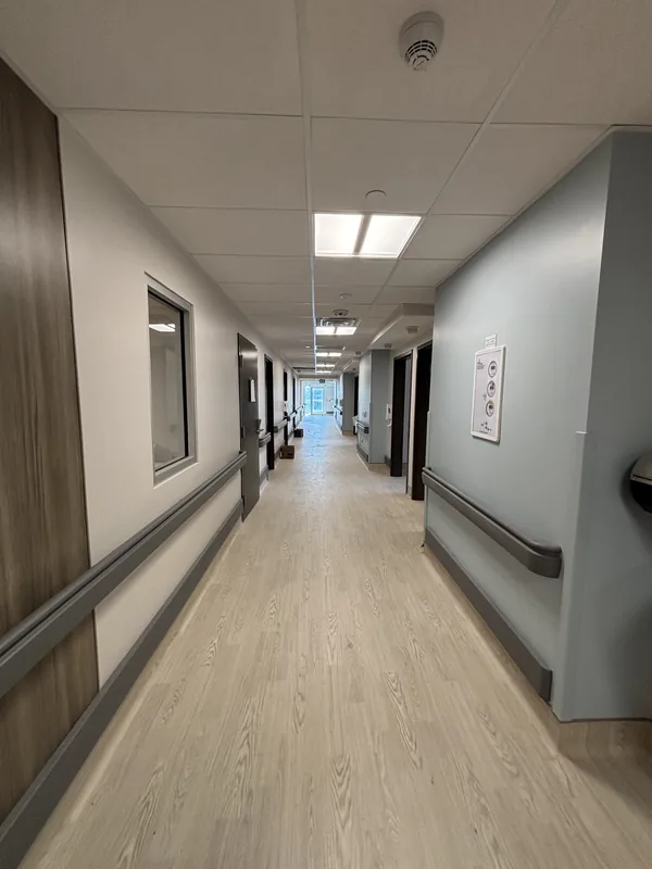P&G Renovation crew painting corridor walls and handrails at LTC St Joseph Village, Hamilton, Ontario